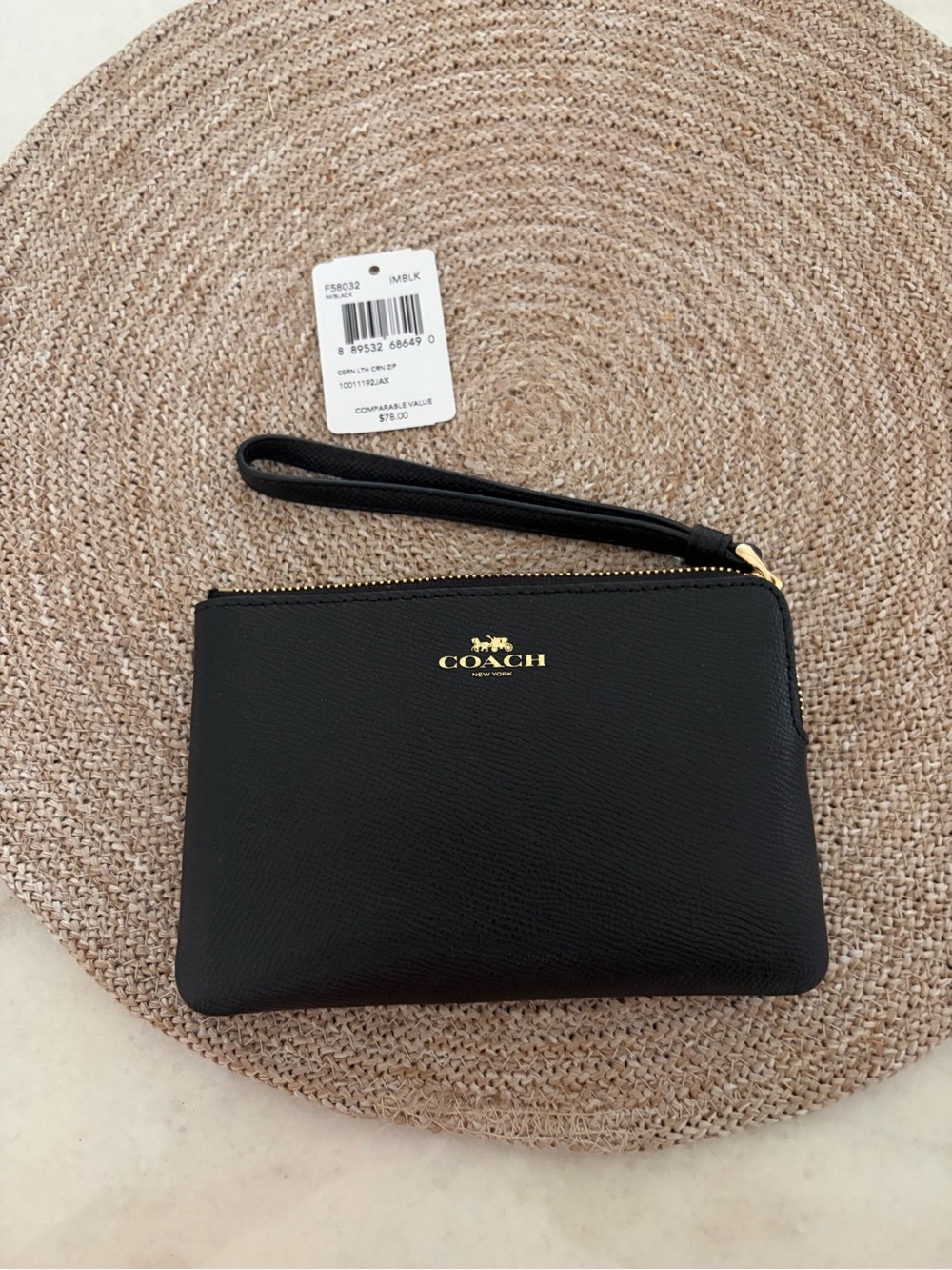 Coach Black Leather Wristlet Clutch with Gold Logo.
